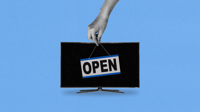 A hand places an open sign on the front of a TV.