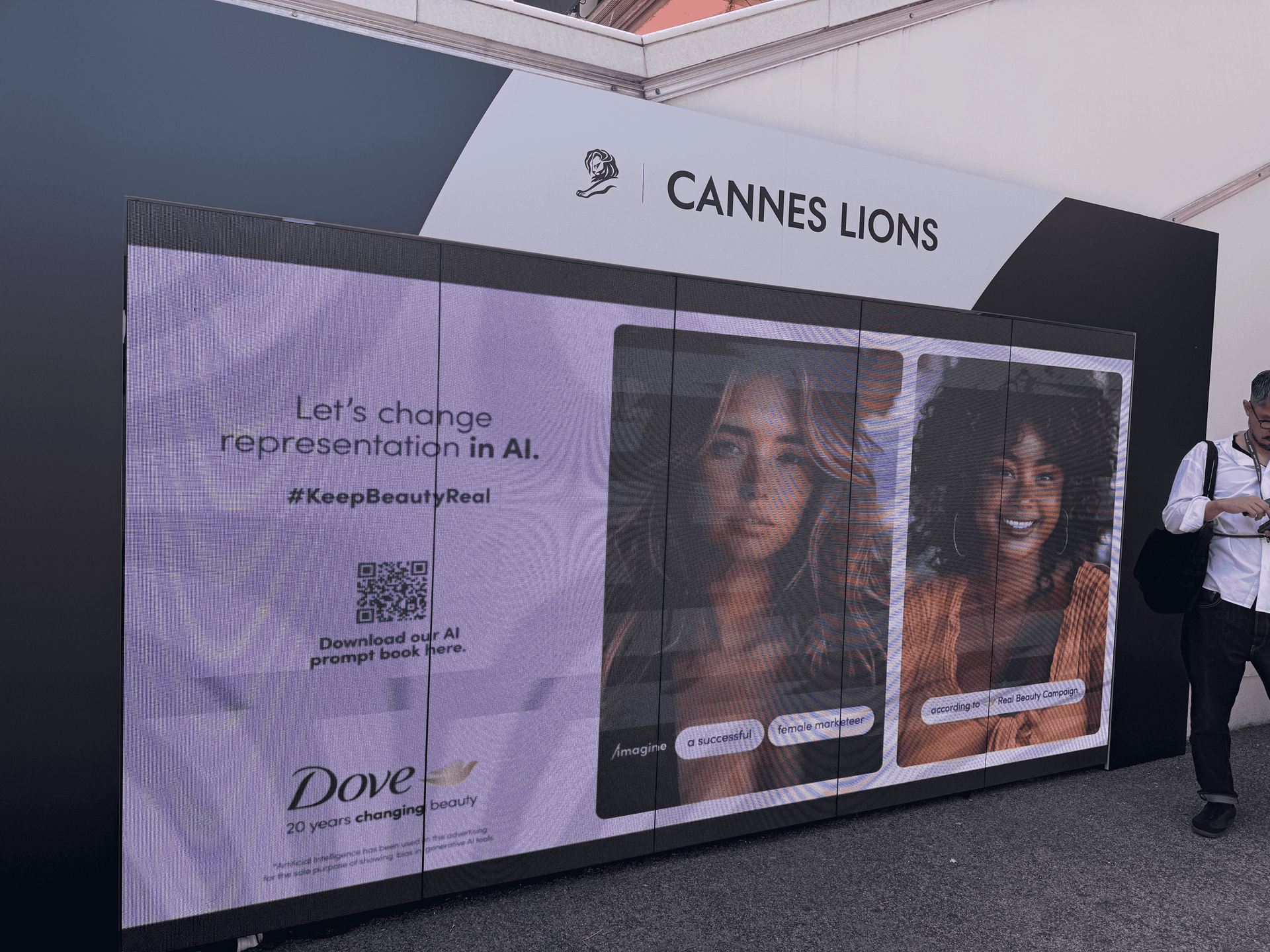 Large screen with a Cannes Lions logo shows a Dove ad with the words "Let's change representation in AI."
