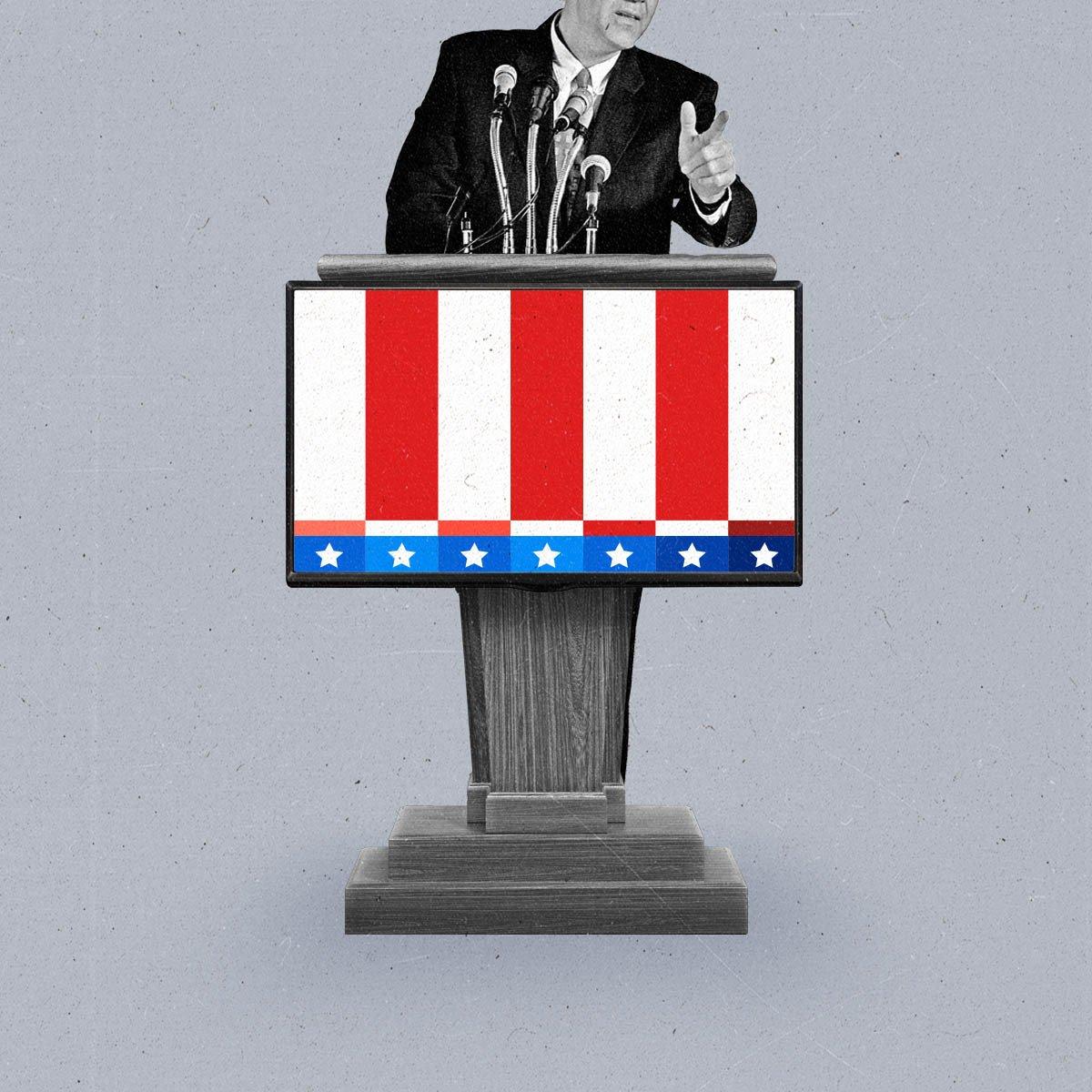 A man in a suit speaks into microphones on a podium that displays a connected TV with a red, white and blue test pattern.