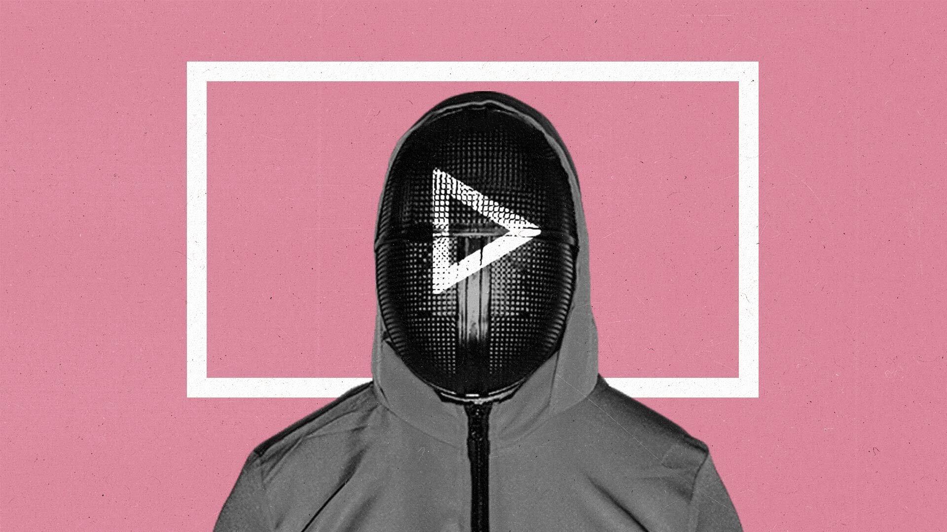 Person in full tracksuit hoodie wearing black fencing mask with a white play button on it stands in front of a white rectangle outline.