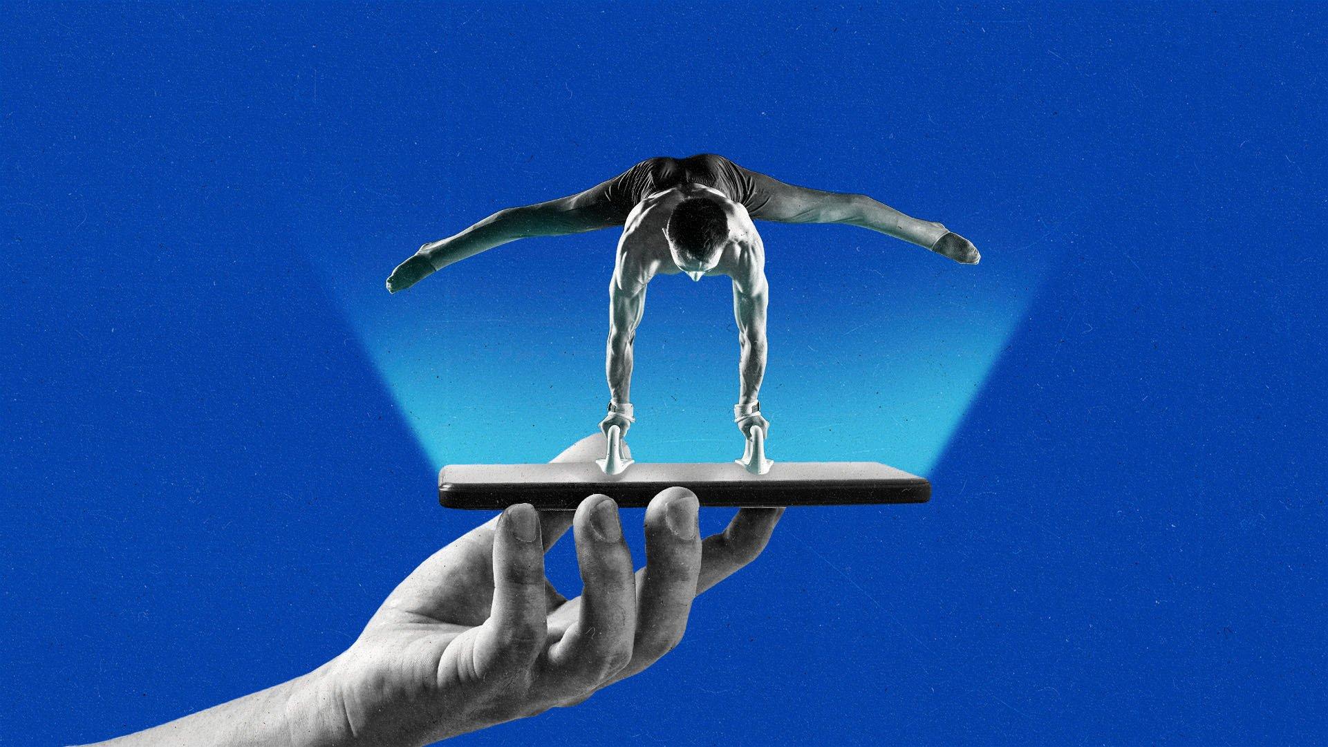 A gymnast holds themselves upside down on pommel horse handles attached to a smart phone.