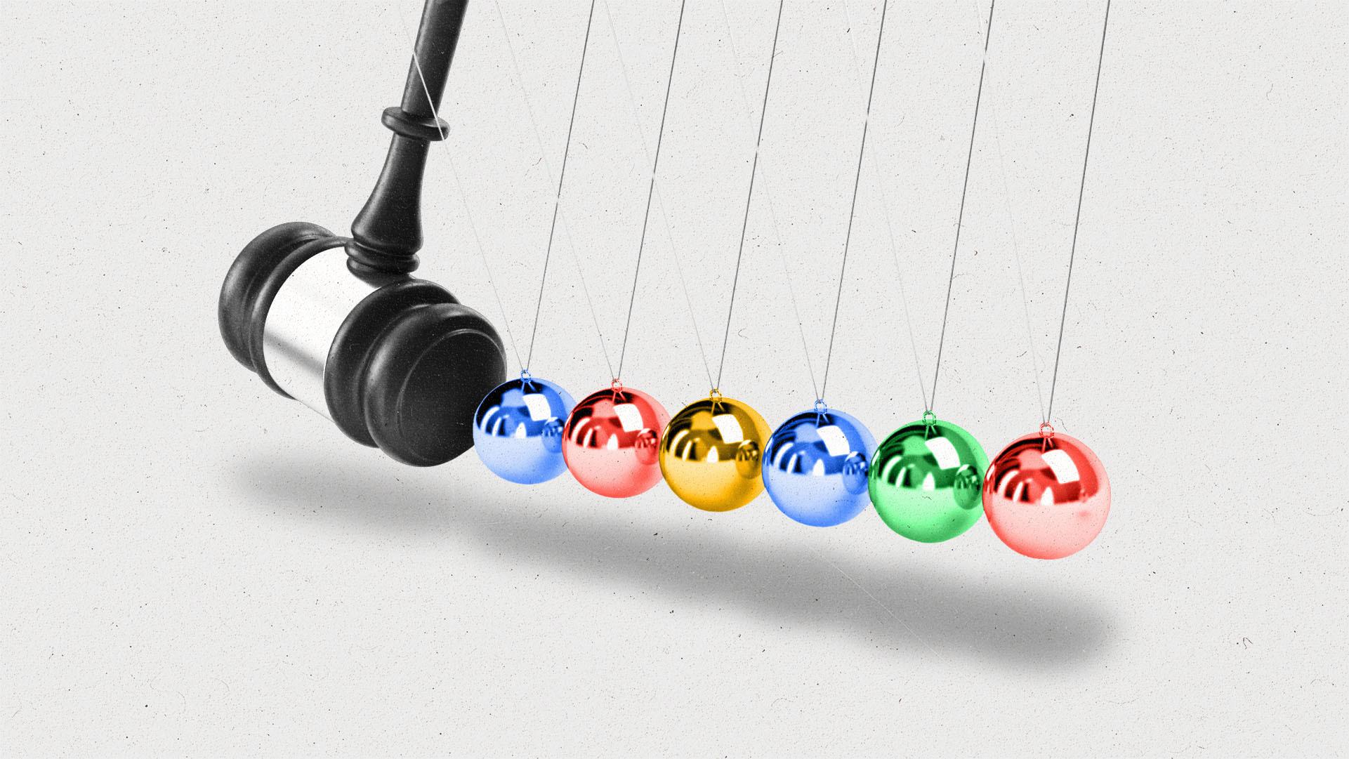 A gavel swinging towards a still Newton's cradle with red, blue, green and yellow balls.