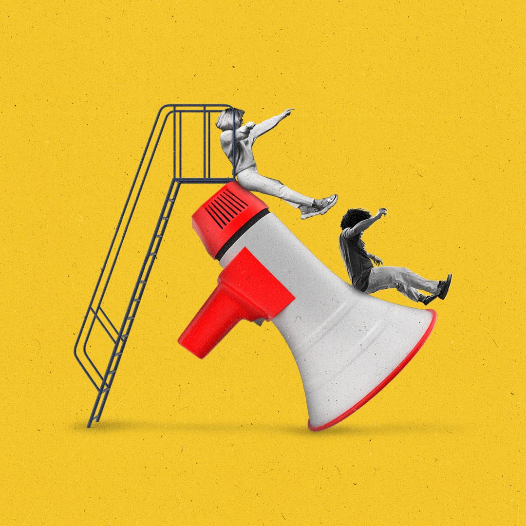 Teens sliding down a megaphone slide