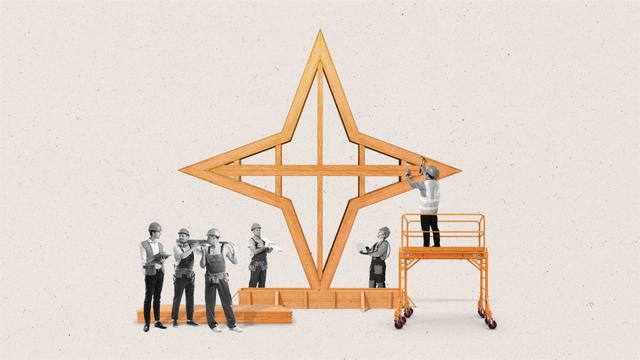 Construction workers build a star shaped structure out of wood resembling an AI sparkle.